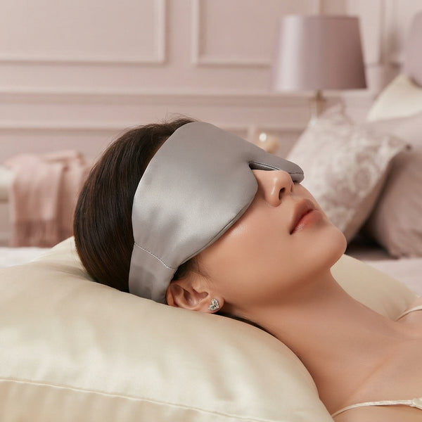 A close-up view of a person wearing a smooth ice silk sleep mask while resting on a soft cream pillow in a serene bedroom.